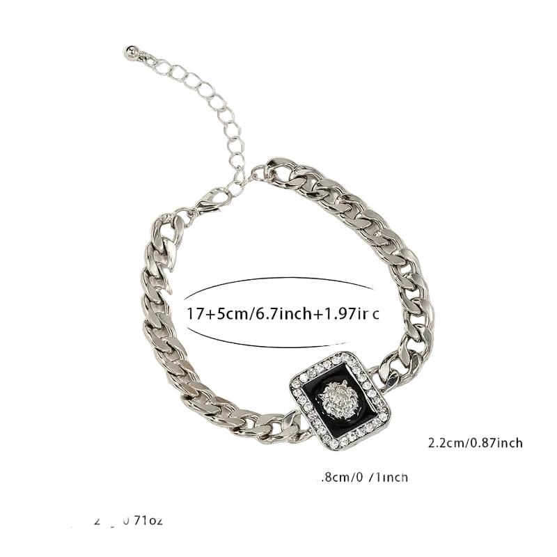 Silver chain bracelet with measurements on a light beige background