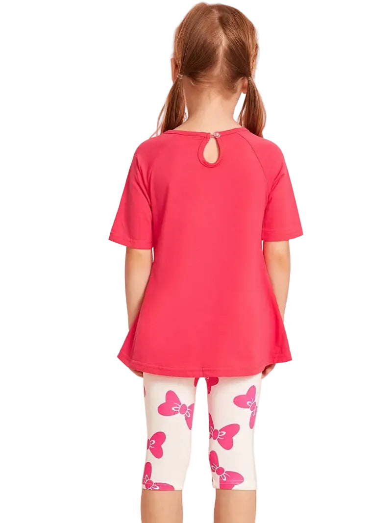 Child wearing a pink shirt and white leggings with pink butterfly patterns on a white background