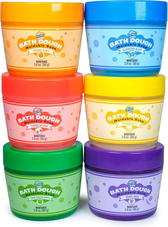 Set of six colorful tubs of bath dough on a white background