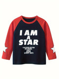 A 3/4 sleeve raglan long-sleeve shirt with a dark navy blue body and red sleeves, featuring the text 'I AM A STAR' in bold white letters on the front, with a white star graphic on the sleeve.