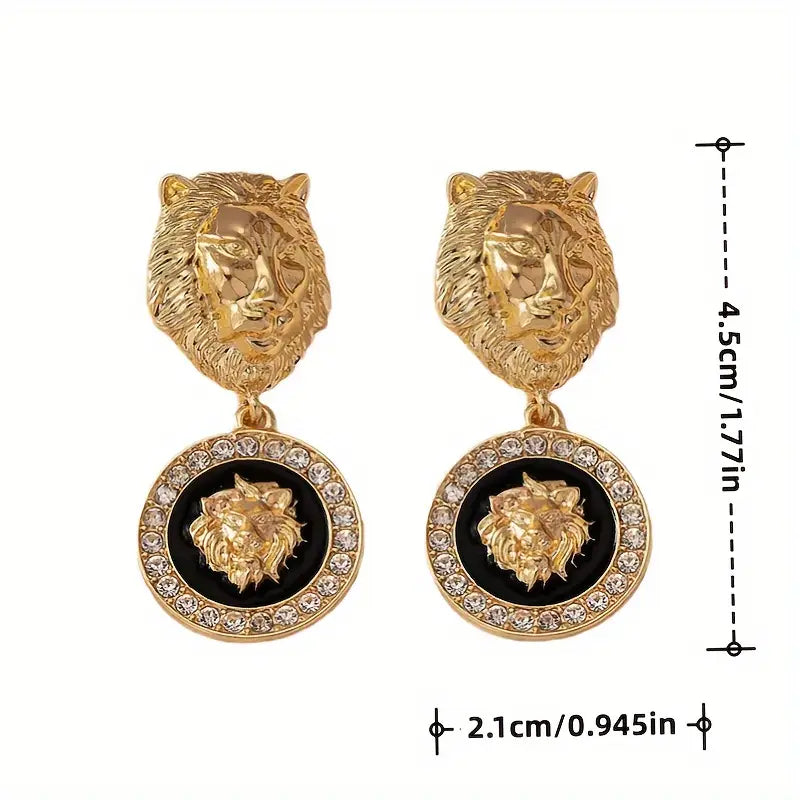 Gold lion head earrings with black centers and measurements on a white background