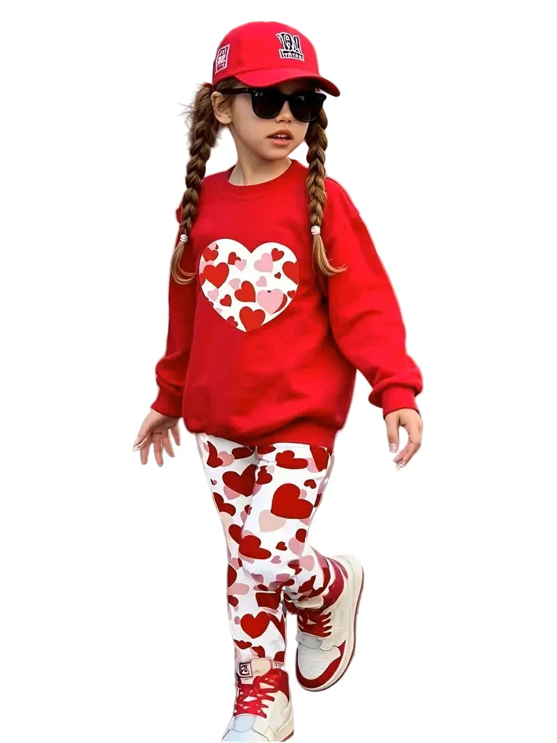 Child wearing a red outfit with heart patterns on a street