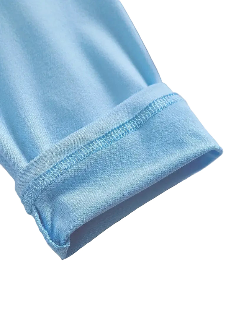 Close-up of light blue fabric with a visible seam on a white background