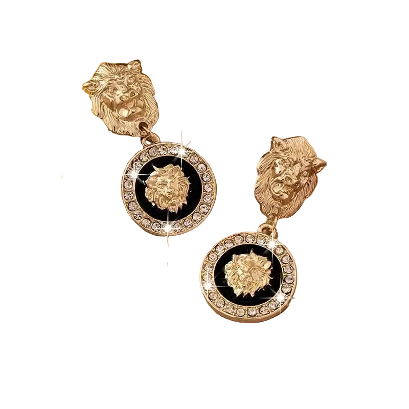 Gold lion head earrings with black centers and diamond-like stones on a beige fabric background Pair Of Drop Earrings Sparkling Inlaid Rhinestone Style