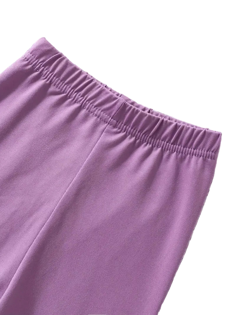 Close-up of purple pants on a textured white background