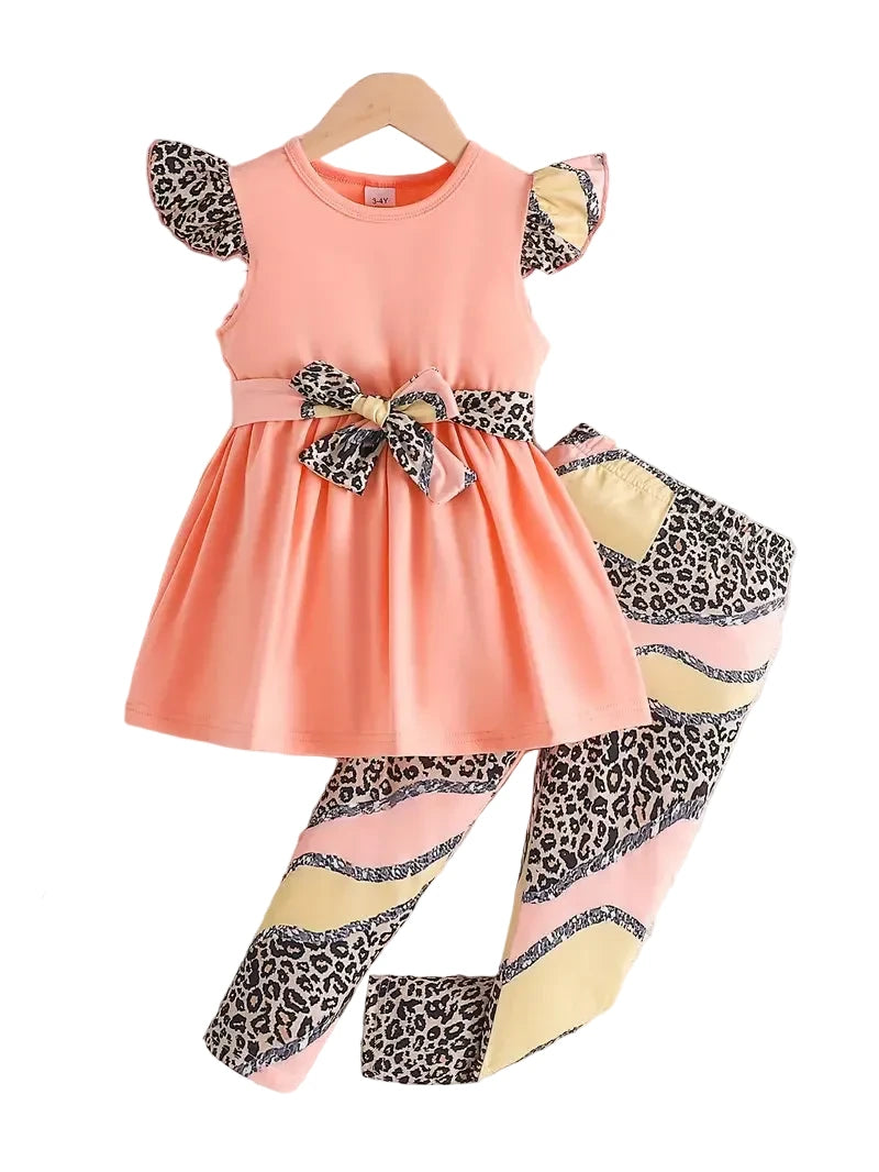 Children's outfit with peach dress and leopard print leggings on a white background