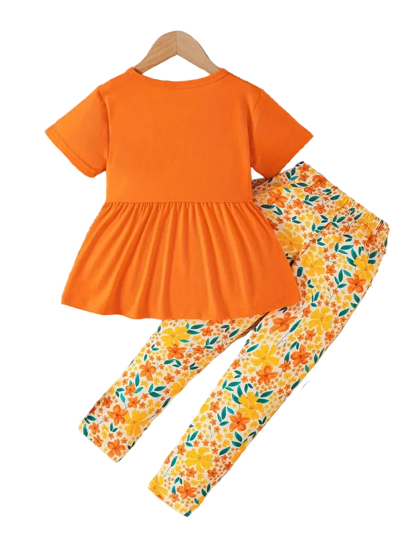 Orange top and floral leggings set on a hanger with a white background