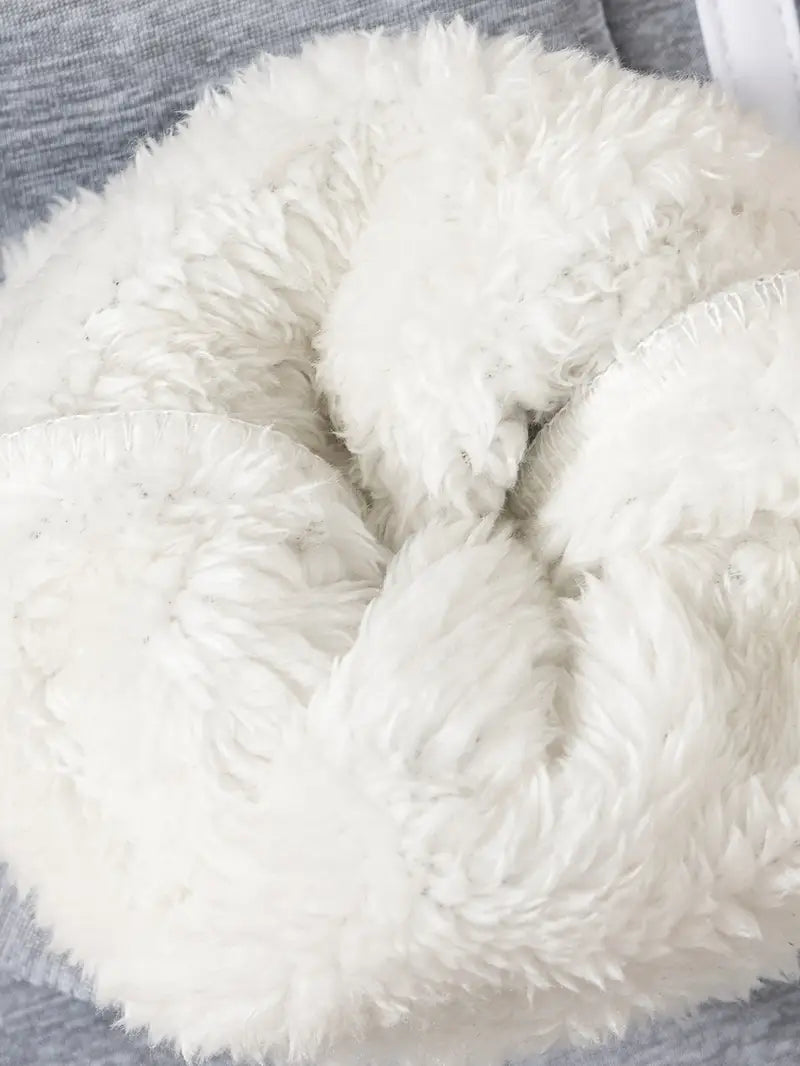 Close-up of a fluffy white pillow on a textured surface