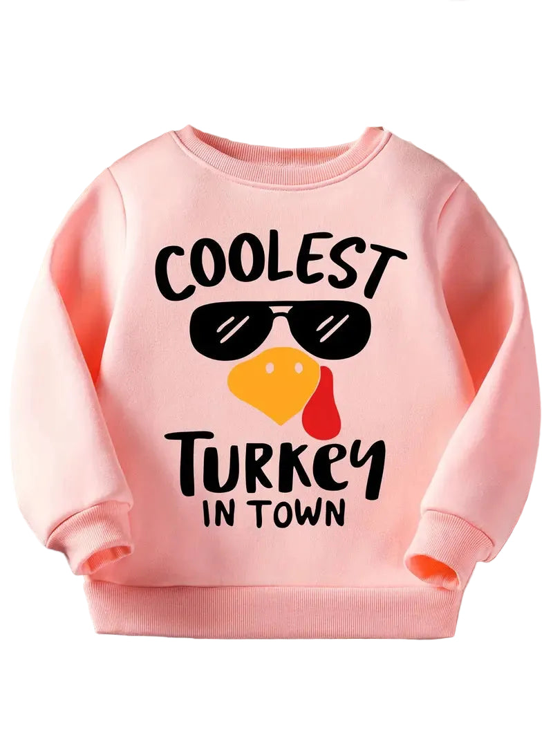Pink sweatshirt with 'Coolest Turkey in Town' text and graphic on a light background