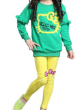 Green sweatshirt with 'Hello Miss Totoy' text and yellow leggings worn by a person on a white background