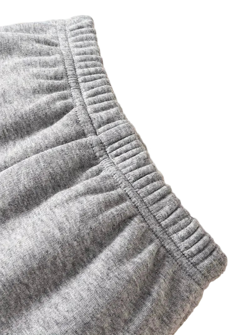 Close-up of gray shorts with a beige background