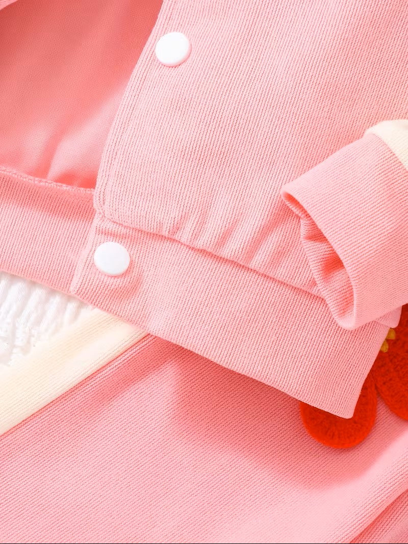 Close-up of a pink jacket with white buttons on a pink background
