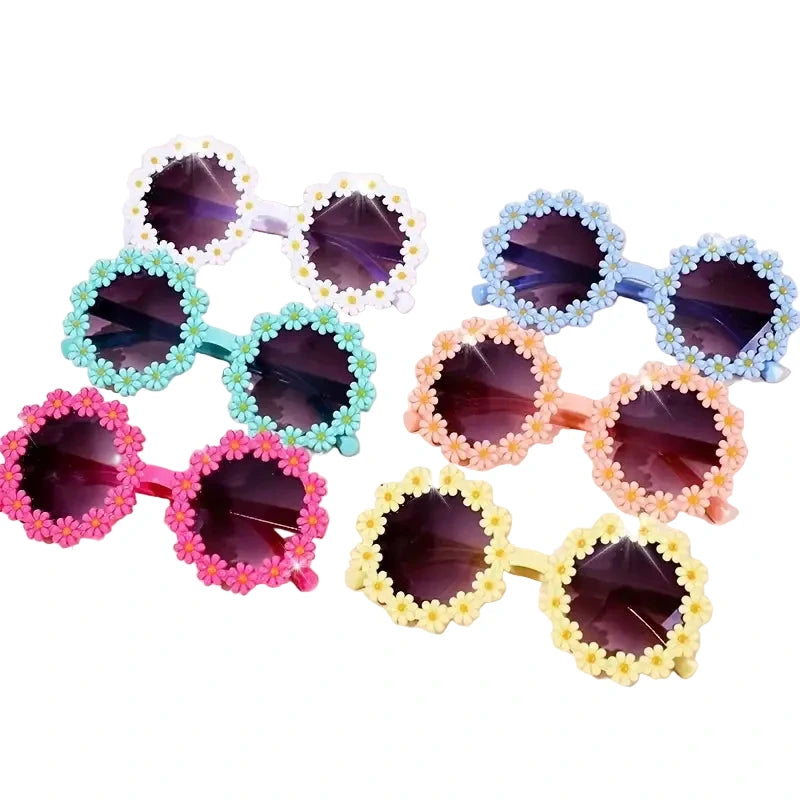 A collection of colorful round sunglasses with decorative patterns around the lens.