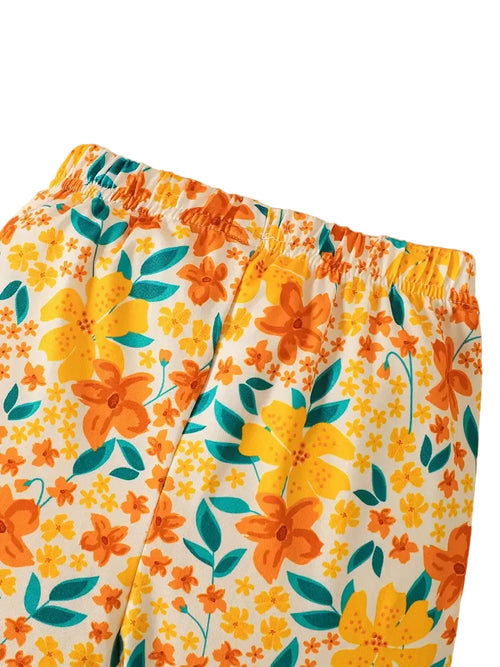 Floral patterned pants with orange flowers on a white background