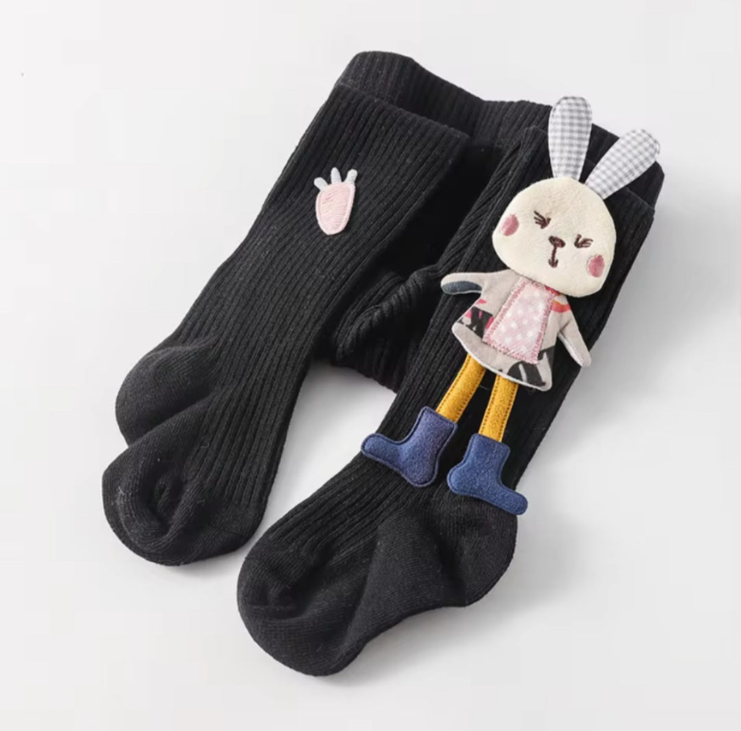 Assorted children's tights with cartoon bunny patterns in various colors.