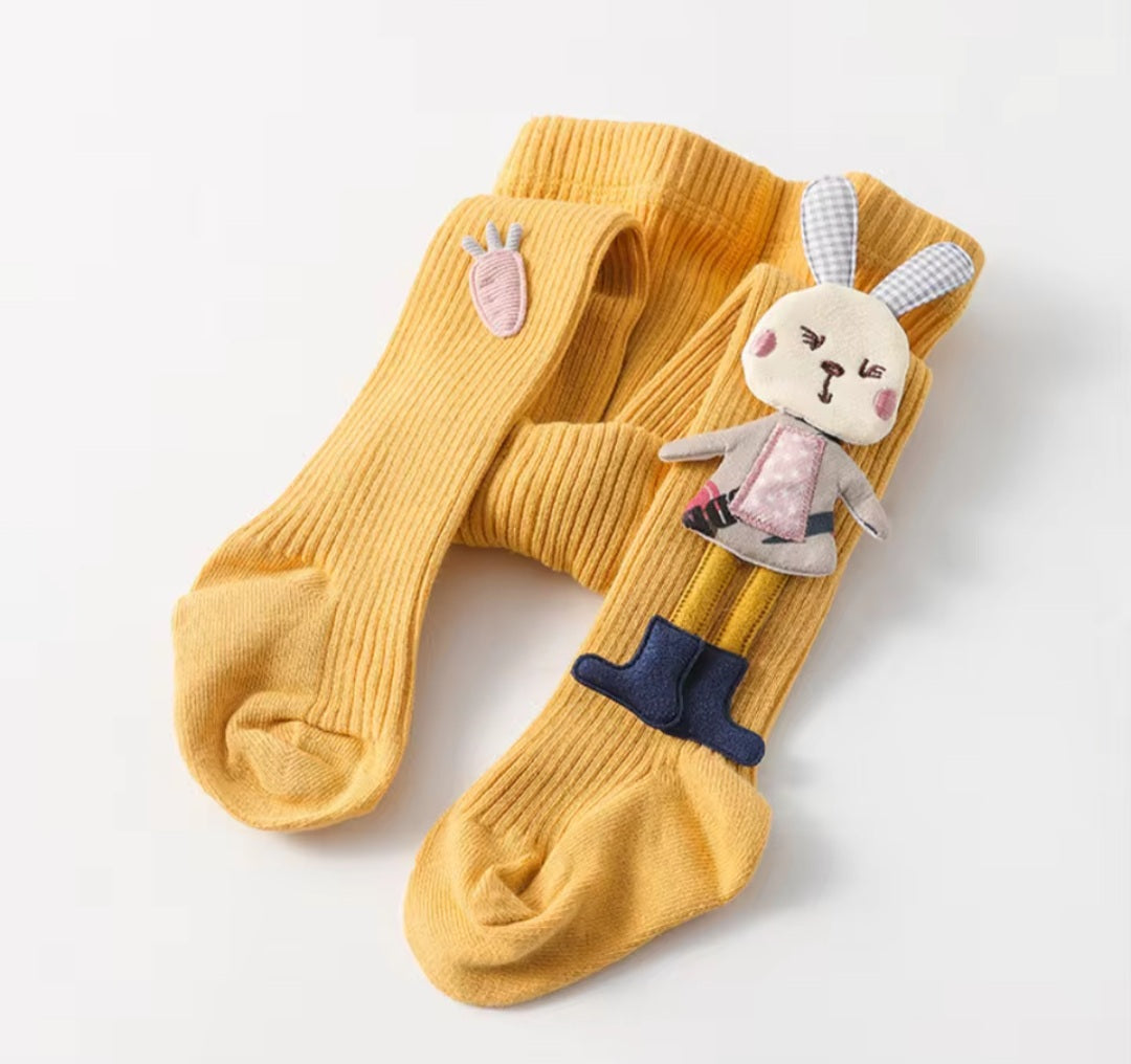 Assorted children's tights with cartoon bunny patterns in various colors.