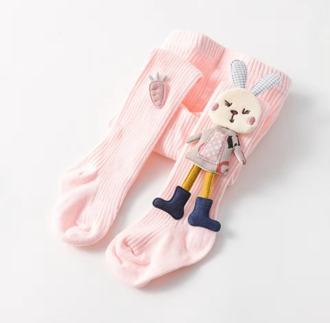 Assorted children's tights with cartoon bunny patterns in various colors.