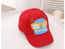Red cap with a cartoon face design featuring glasses on a white surface.