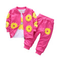 Pink children's outfit with yellow flower patterns on a white background