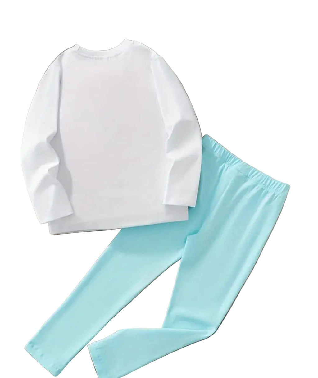 White sweatshirt and light blue pants on a wooden surface with flowers and a bicycle toy.