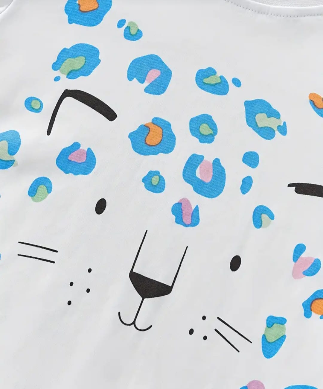 White shirt with colorful leopard print design on a white background