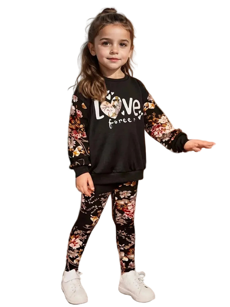Young girl wearing a black 'Love' sweatshirt with floral sleeves and matching leggings on a white background