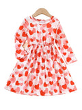 Children's dress with red and pink heart pattern on a white background