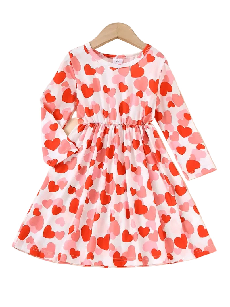 Children's dress with red and pink heart pattern on a white background