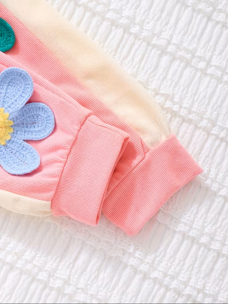Pink fabric with a blue flower patch on a textured white background