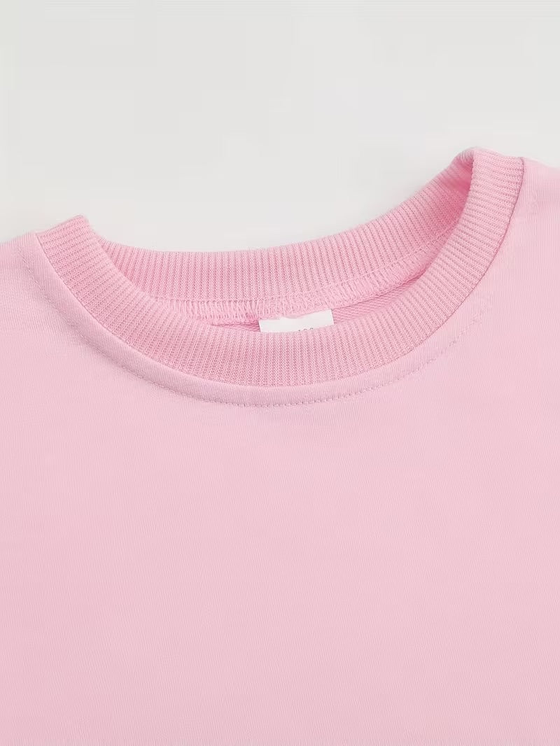 Close-up of a pink sweater collar on a light gray background
