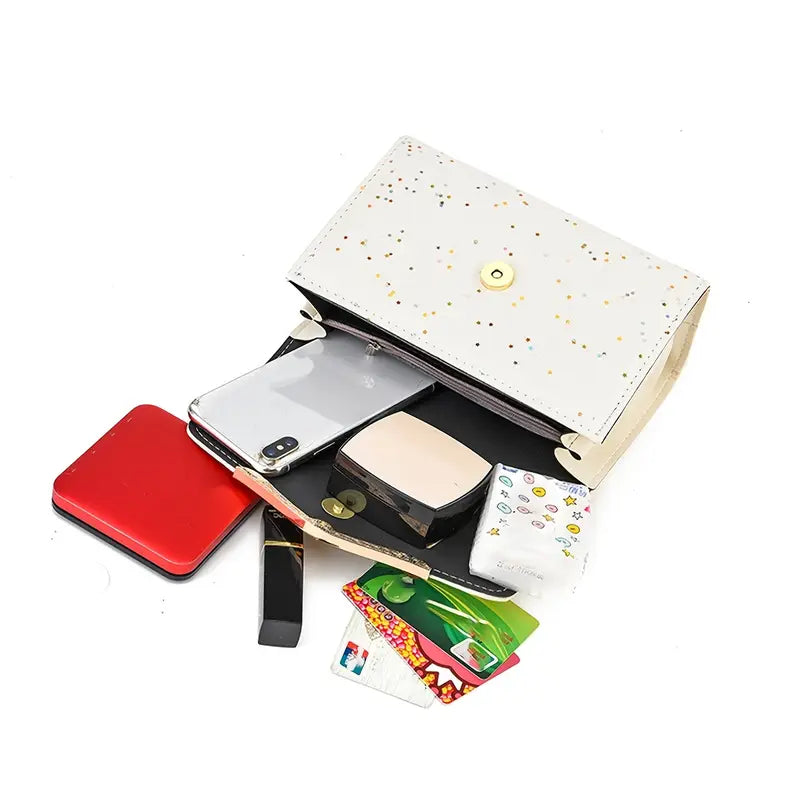 Open white handbag with phone, wallet, and cards on a white background