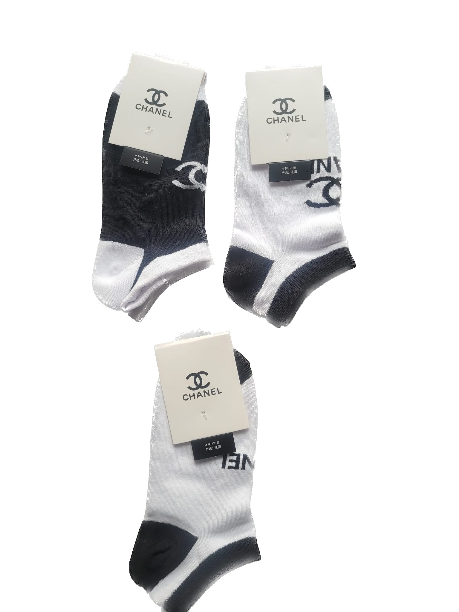 Three pairs of black and white socks with Chanel branding on a white background