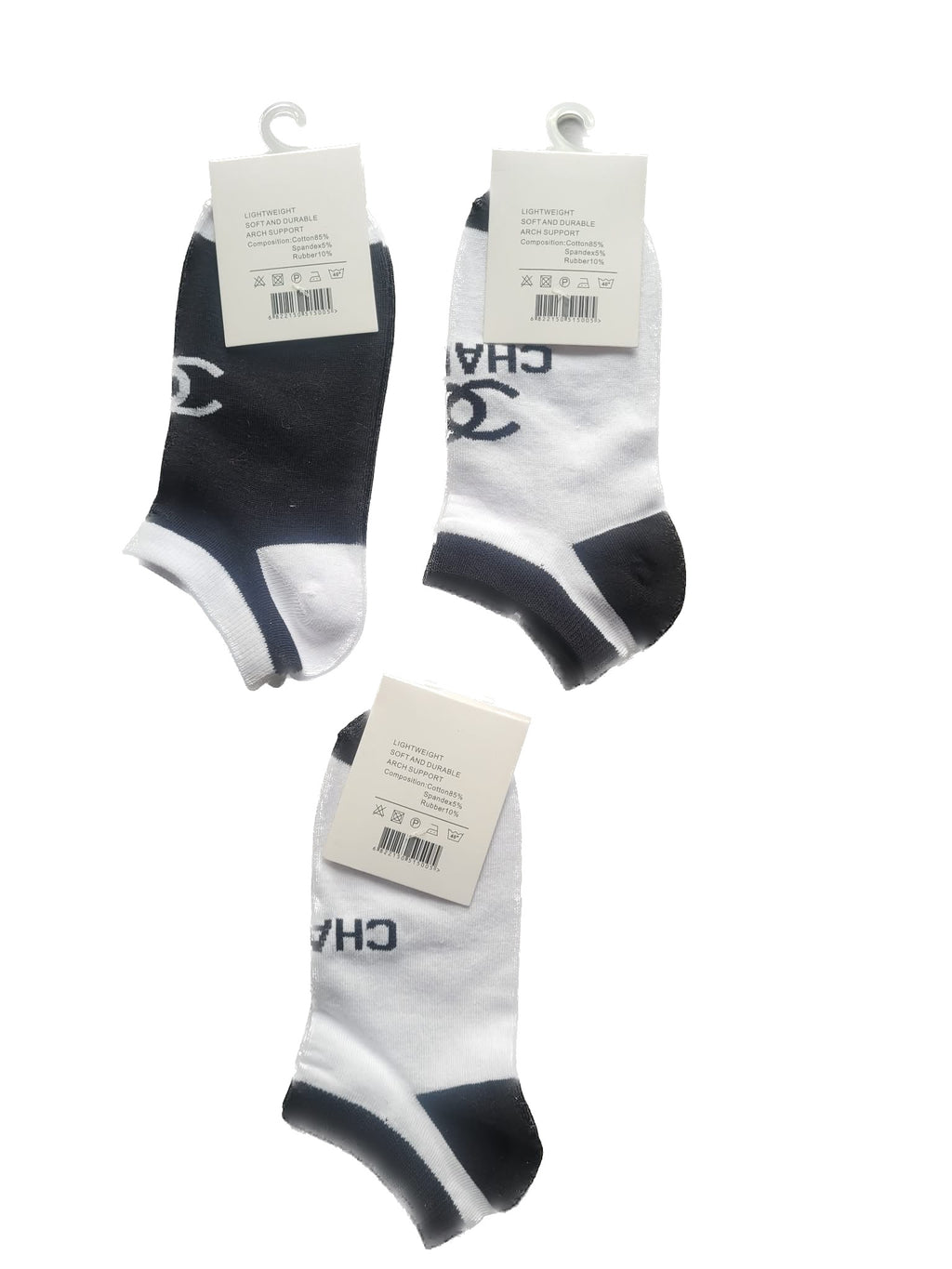 Three pairs of black and white socks with brand tags on a white background