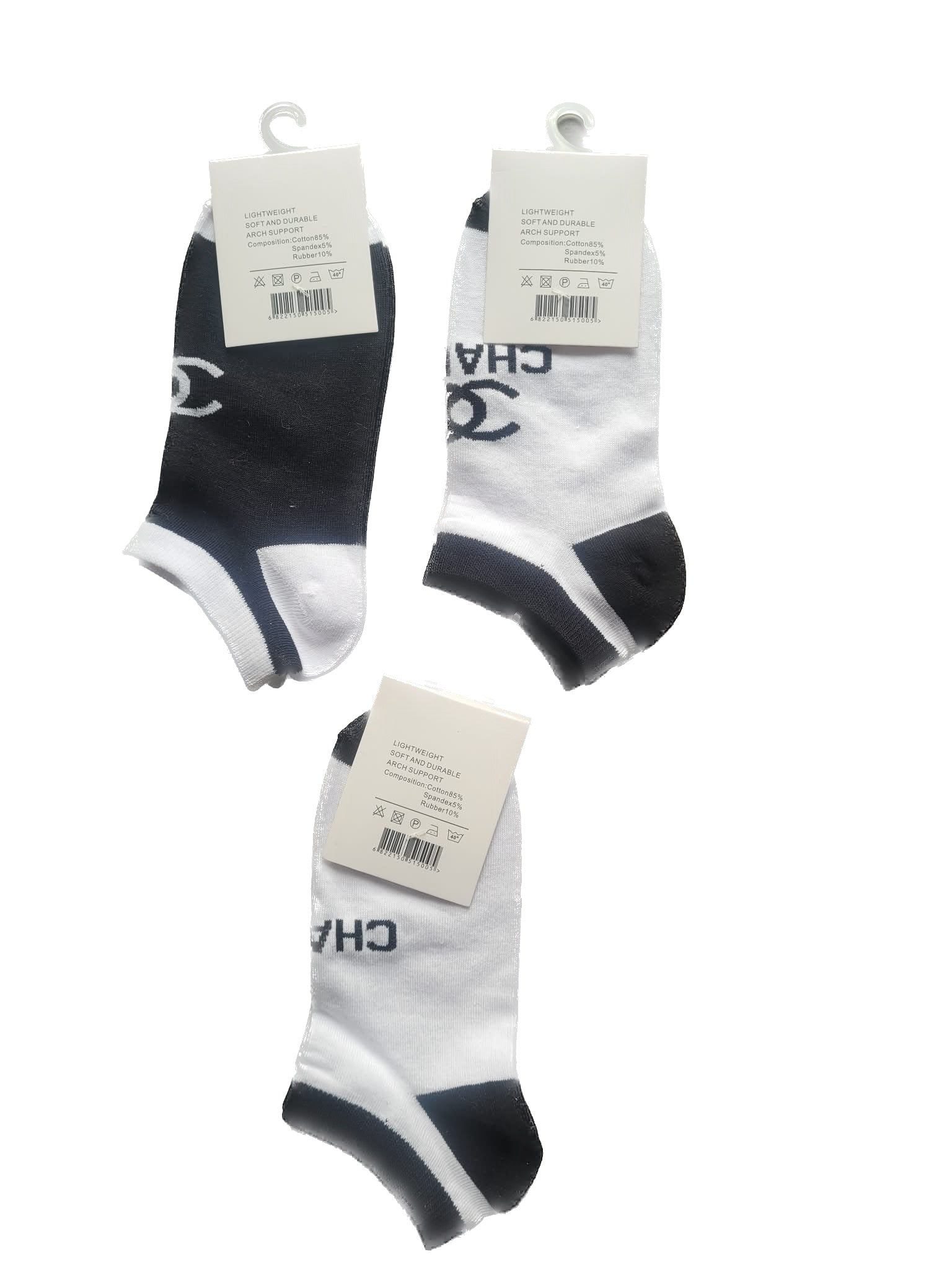 Three pairs of black and white socks with brand tags on a white background