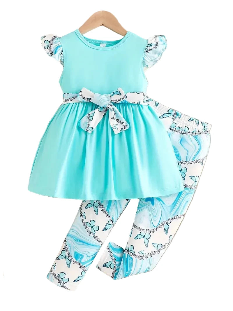 Children's outfit with turquoise dress and floral pants on a white background