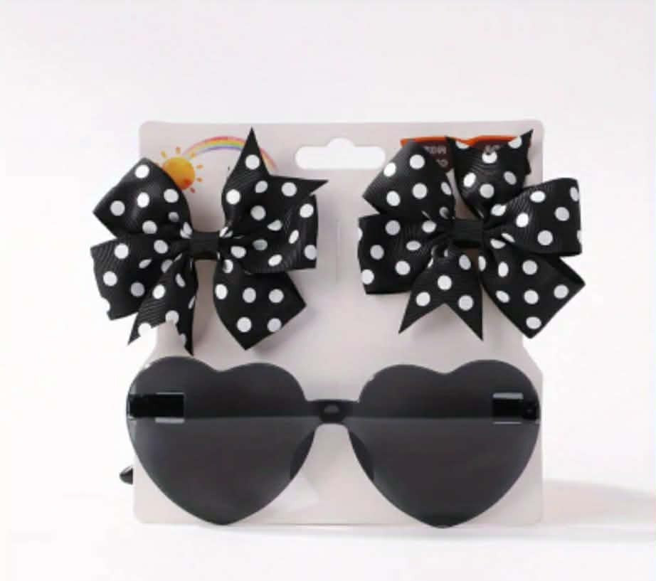 Black heart-shaped sunglasses with polka dot bows on a white background
