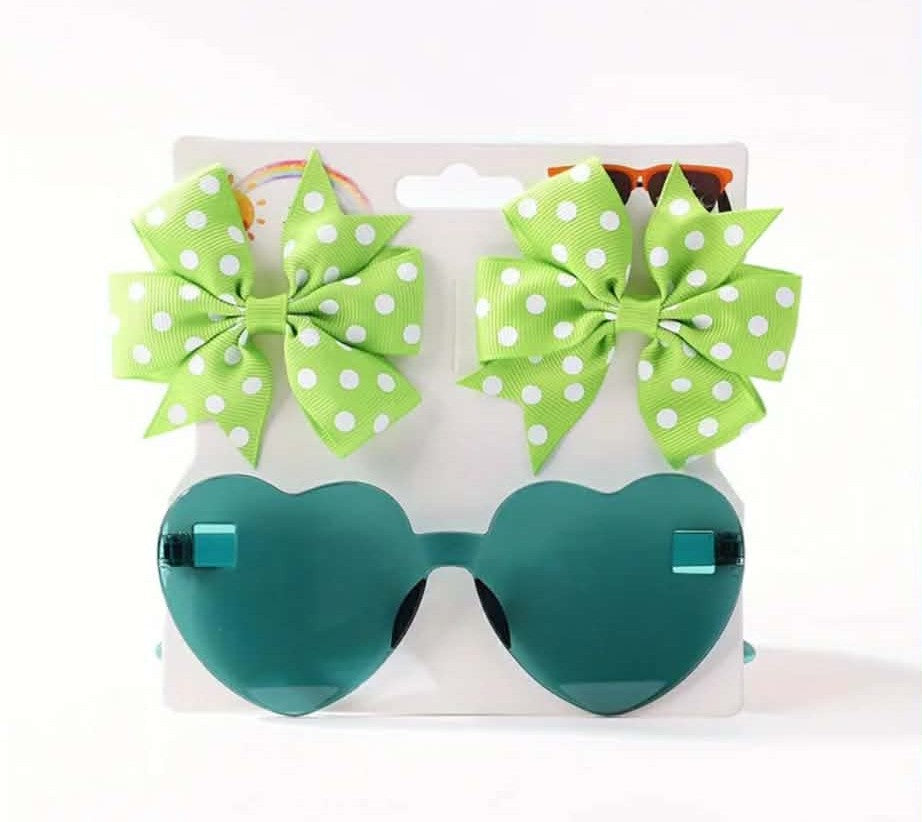 Green heart-shaped sunglasses with green polka dot bows on a white background