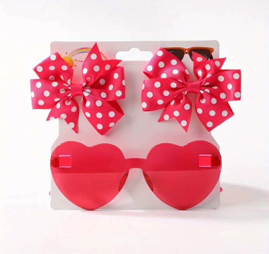 Red heart-shaped sunglasses with red bows with white polka dots on a white background