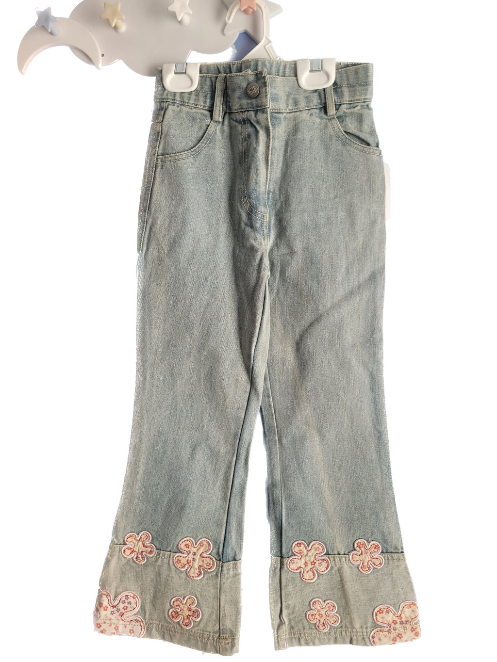 Denim pants with floral embroidery on a white background