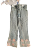 Denim pants with floral embroidery on a white background