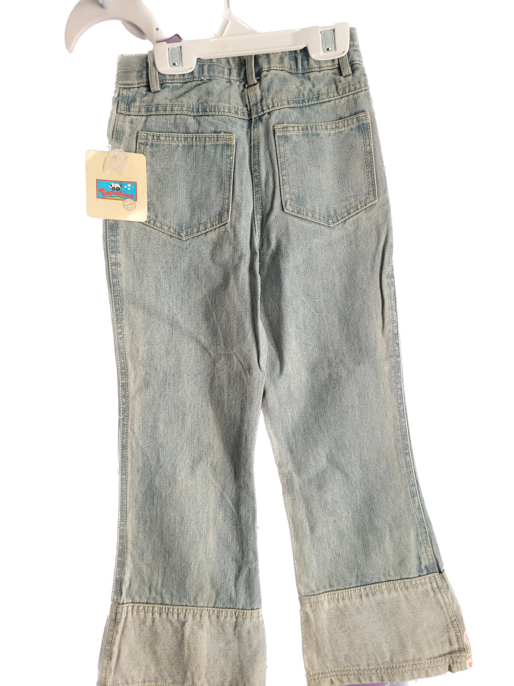 Light blue jeans with a tag on a white background