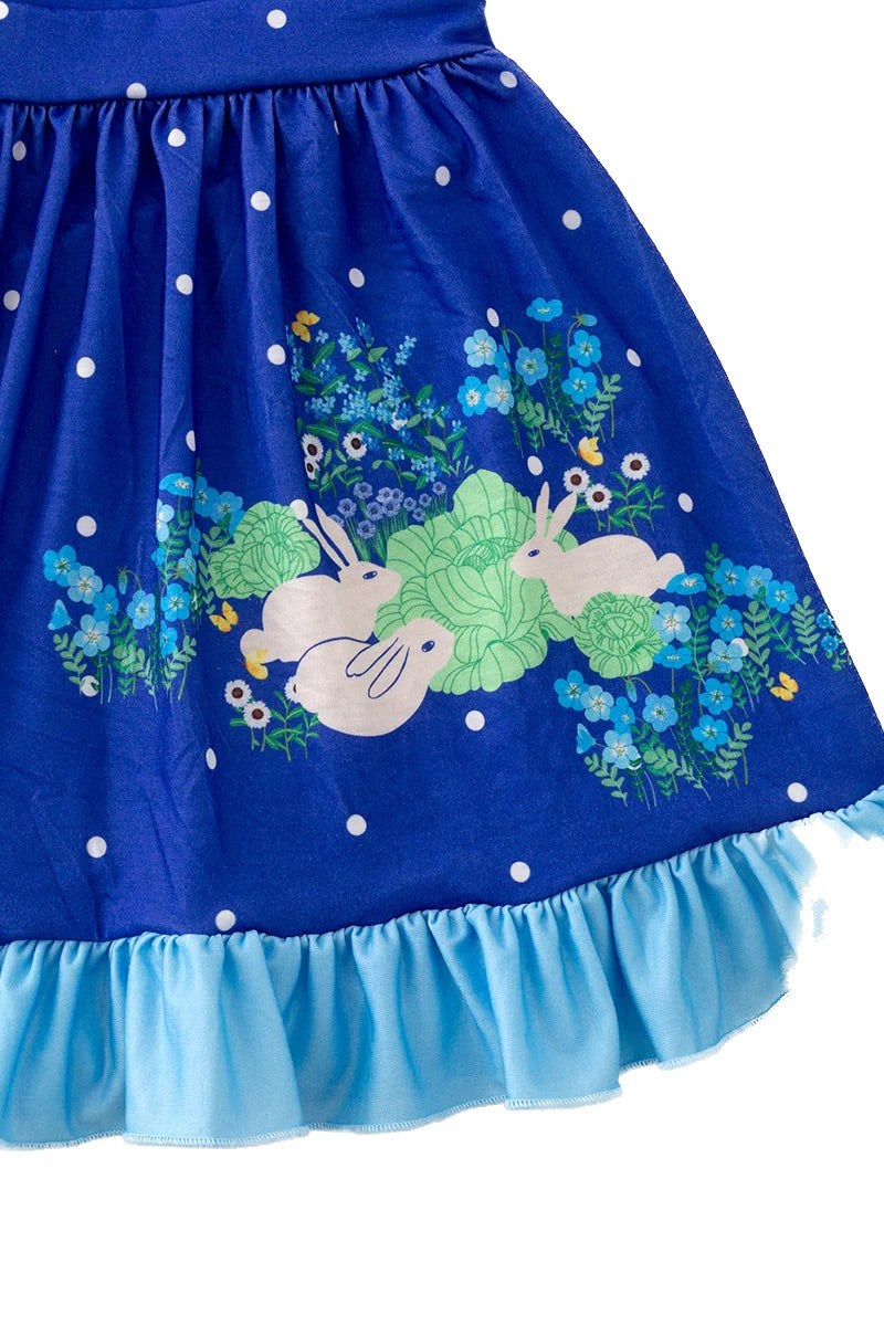 Children's dress with blue and white polka dot top and blue skirt, featuring cartoon bunnies and flowers 