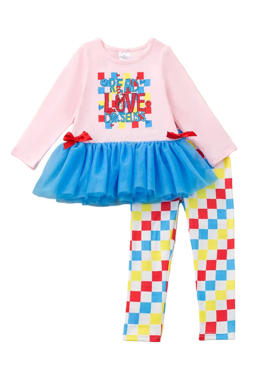 Children's outfit with pink top, blue tutu, checkered leggings, and red hair accessory on a fluffy white surface. dr seus outfit set