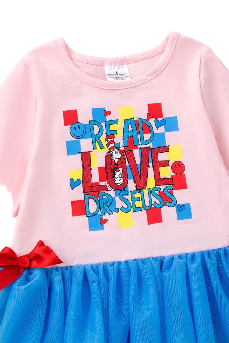 Pink dress with colorful text and blue skirt 
