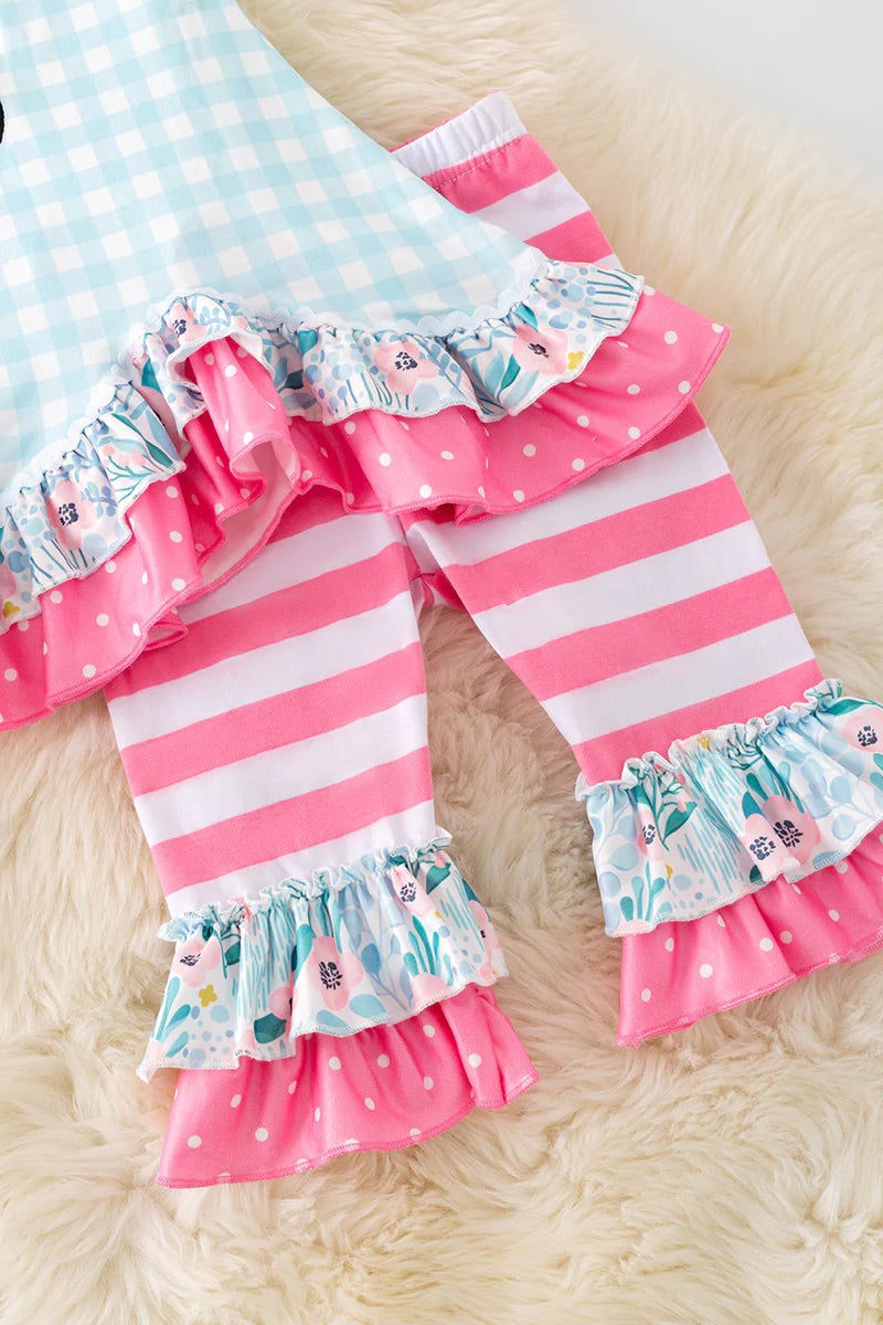 Pink and white striped leggings with floral ruffles on a light background