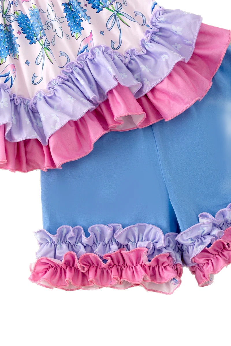 Children's outfit with ruffled shorts and top on a white background