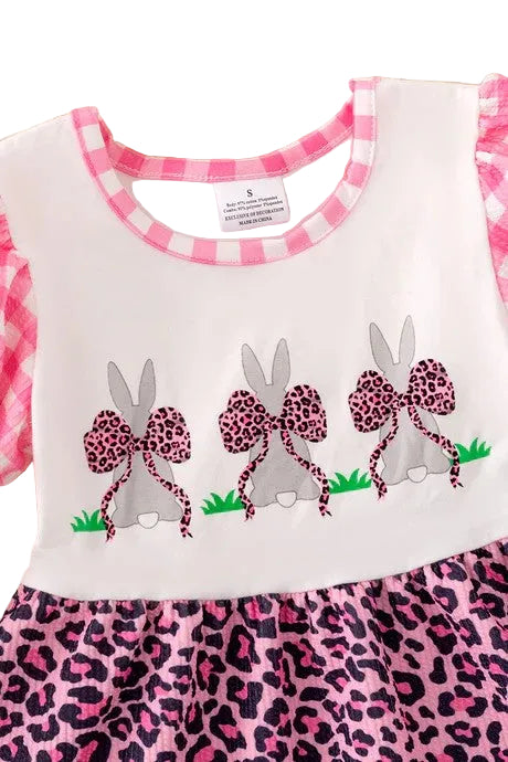 Children's dress with pink and leopard print details on a white background