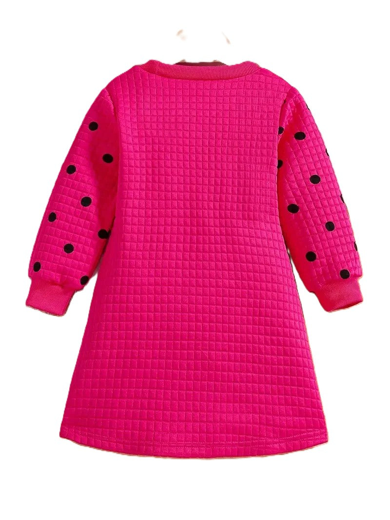 Pink dress with black polka dots on a white background
