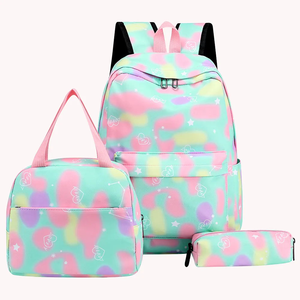 Set of pastel-colored backpack, lunch bag, and pencil case with a flamingo pattern on a white background.
