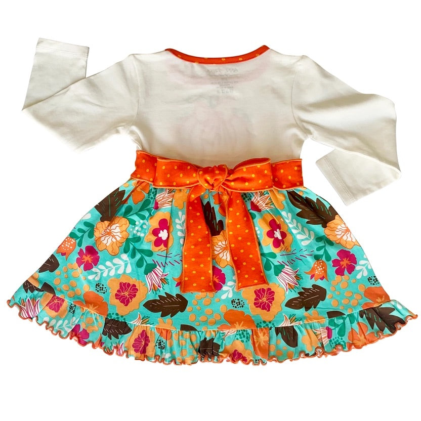 Colorful dress with floral skirt and orange polka dot ribbon on a white background